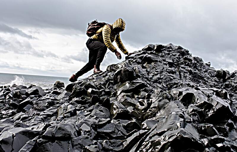 Person scrambling over rocks