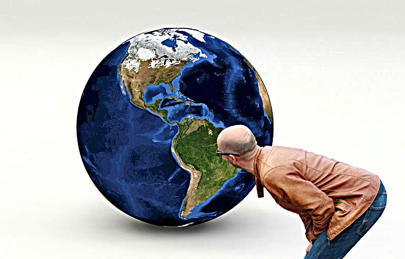 Man staring at a giant globe